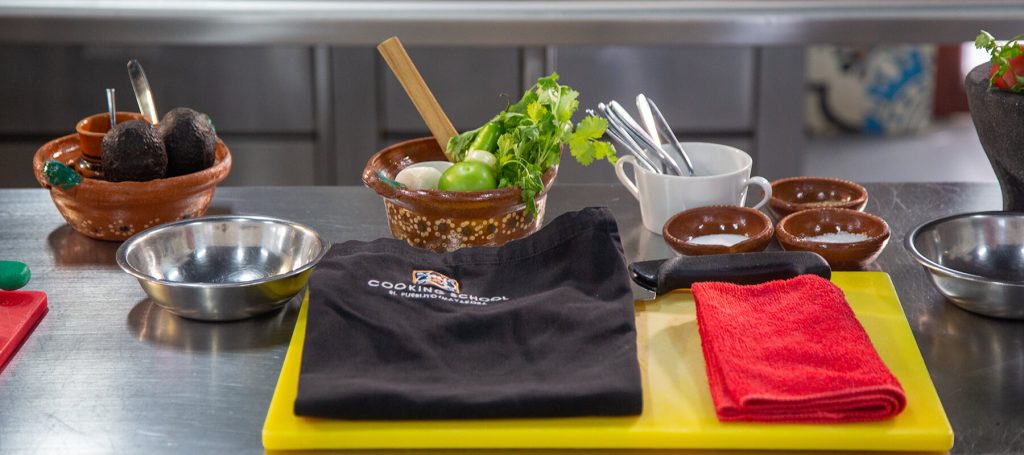 apron, utensils and food cooking class setup