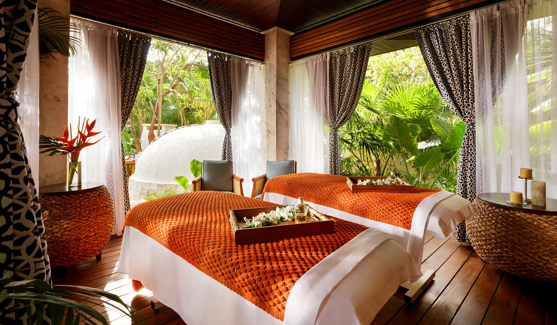 massage beds in private palapa room open to lush jungle greenery