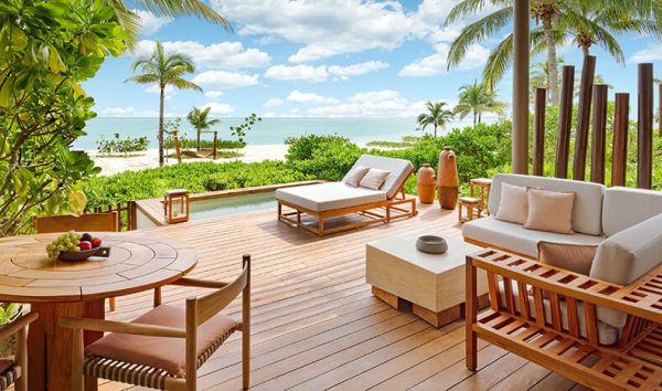 beachfront hotel suite with large wood deck and cabanas