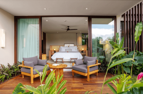 terrace with lush landscaping opens to serene bedroom suite