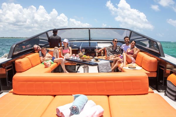family in a yacht in the caribbean in front of Mayakoba beach