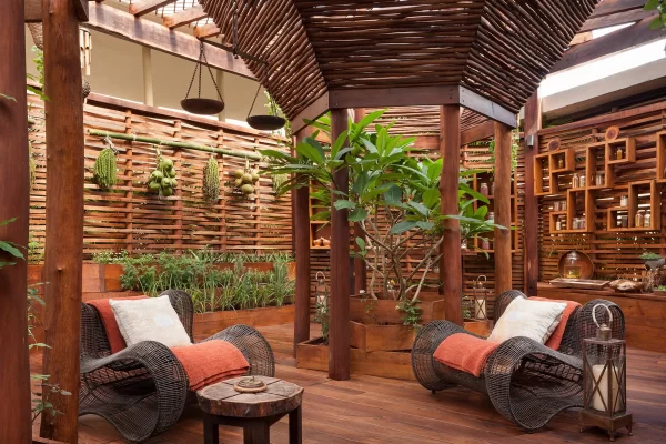 spa garden setting with lounge chairs and fresh herb plants