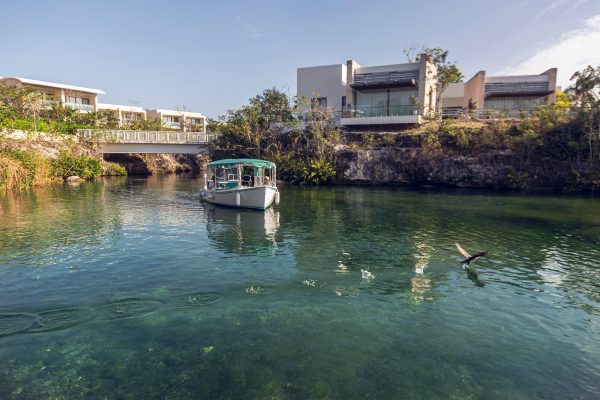 eco boat tour cruises through canal at andaz mayakoba