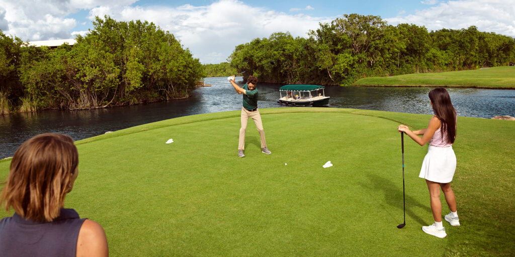 golfer swings as boat drives by in canal