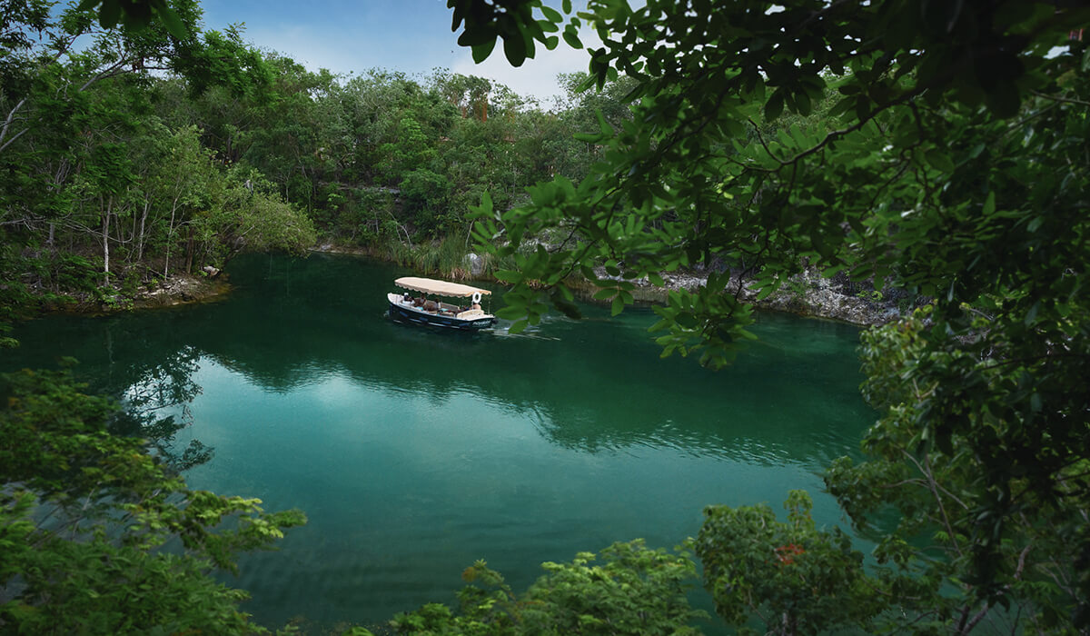 boat cruises through mayakoba canal