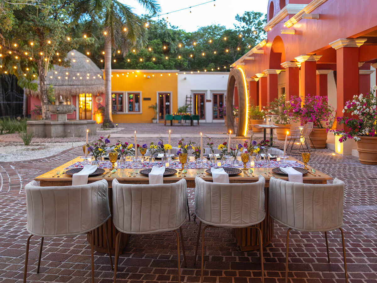 festive table setting in traditional mexican square with cobblestone