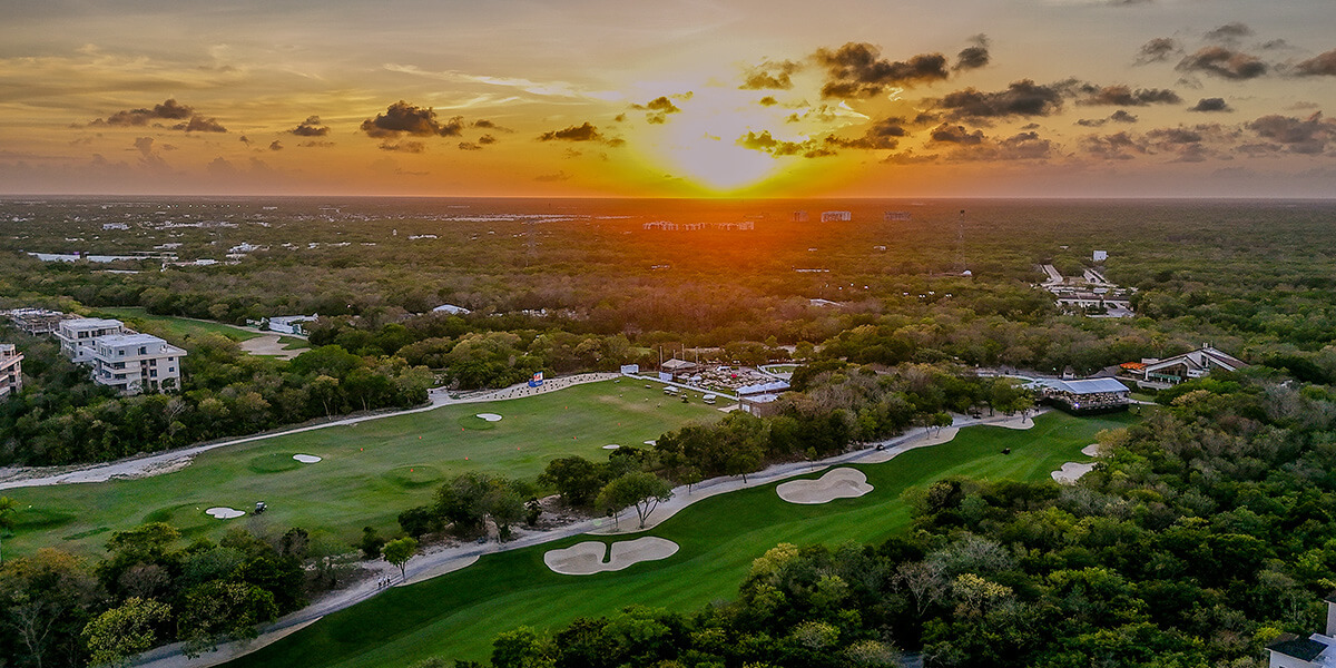 sun sets at golden hour across golf course